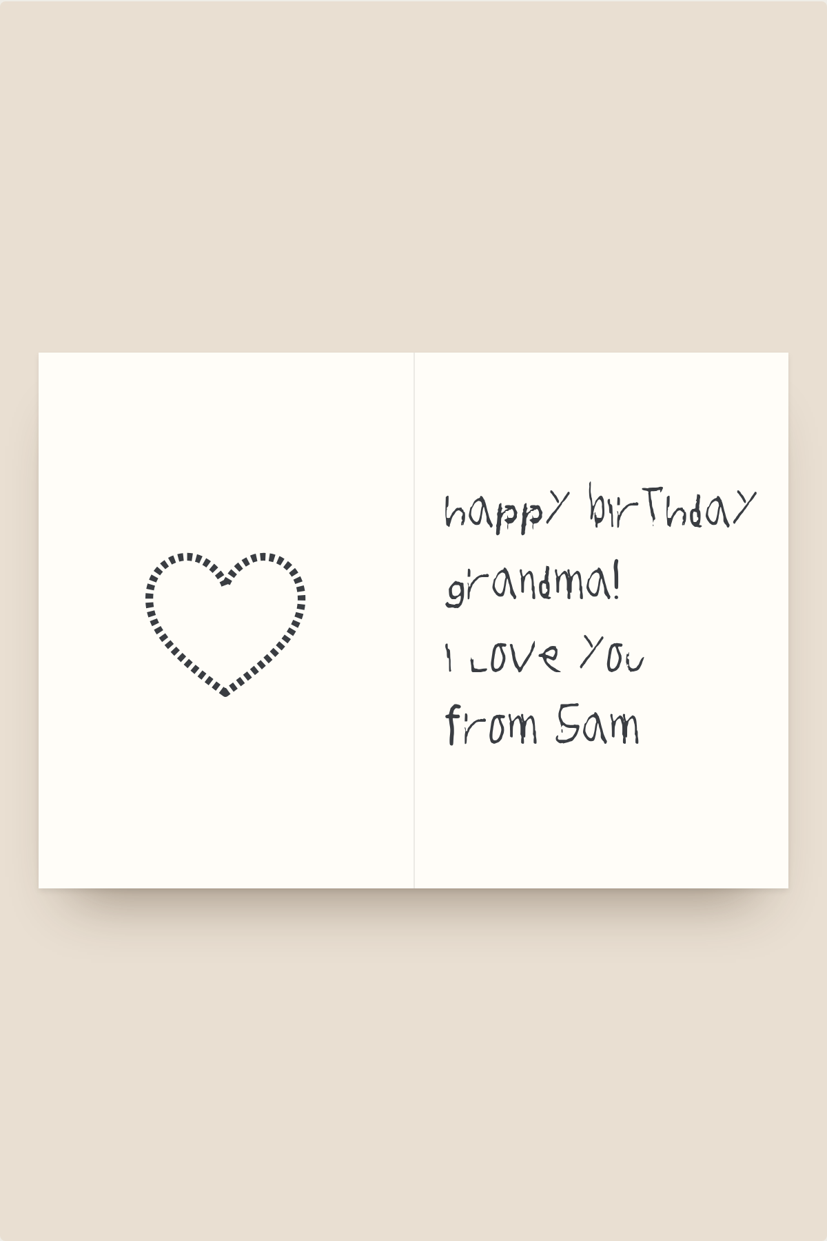 Folded birthday card with a child's handwritten message and a drawn heart